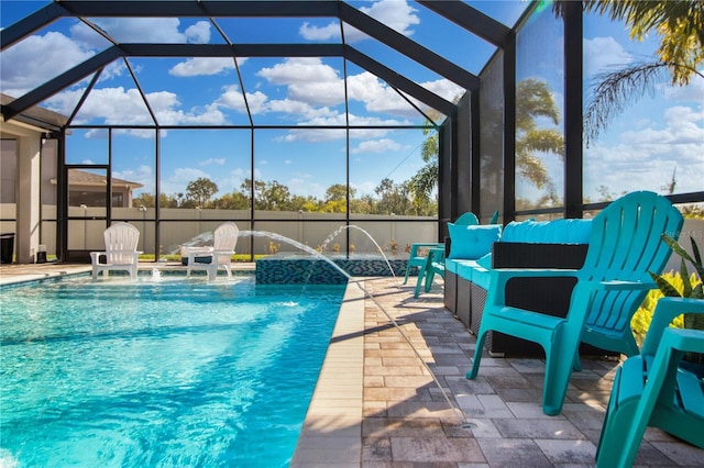 view of swimming pool featuring pool water feature, glass enclosure, and a patio