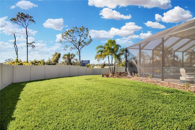 view of yard with glass enclosure