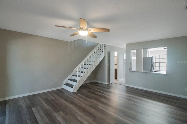 unfurnished living room with ceiling fan and dark hardwood / wood-style flooring