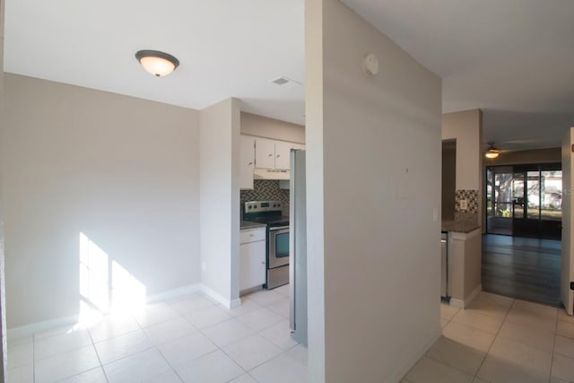 hall featuring light tile patterned flooring