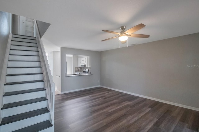 stairway with wood-type flooring, ceiling fan, and sink