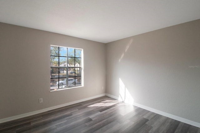 unfurnished room featuring dark wood-type flooring