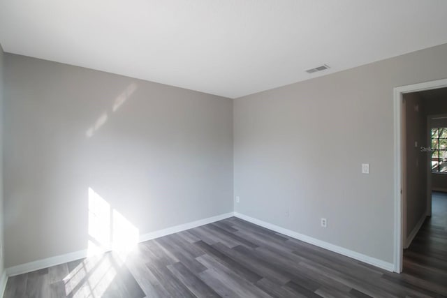 empty room with dark wood-type flooring