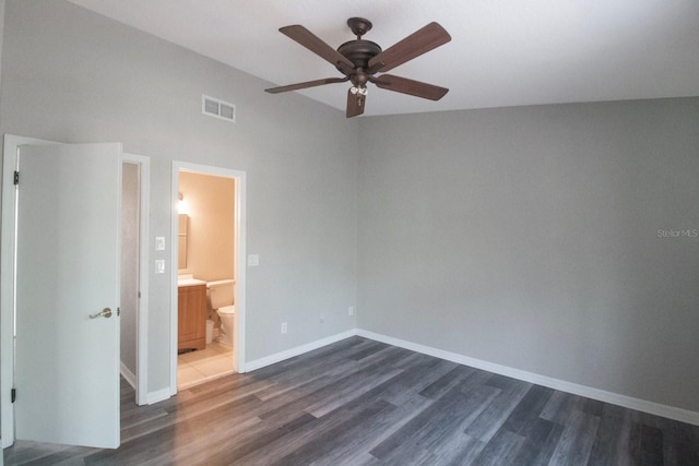 unfurnished bedroom with ceiling fan, dark hardwood / wood-style flooring, and ensuite bath