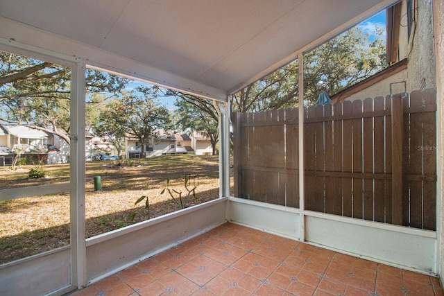 unfurnished sunroom with lofted ceiling and a wealth of natural light