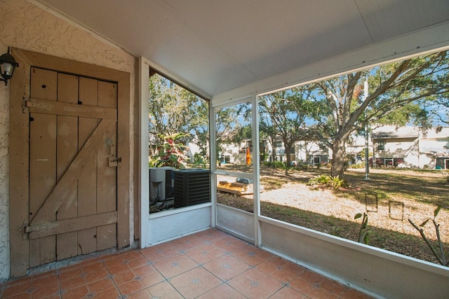 unfurnished sunroom featuring lofted ceiling