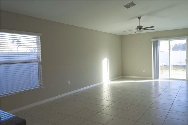 tiled empty room with ceiling fan