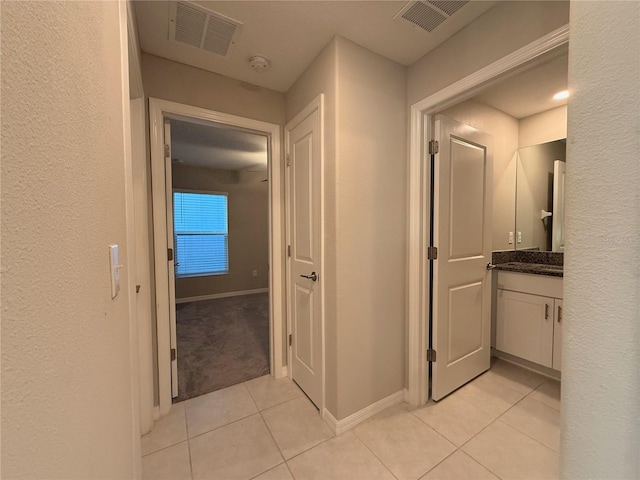 corridor with light tile patterned floors