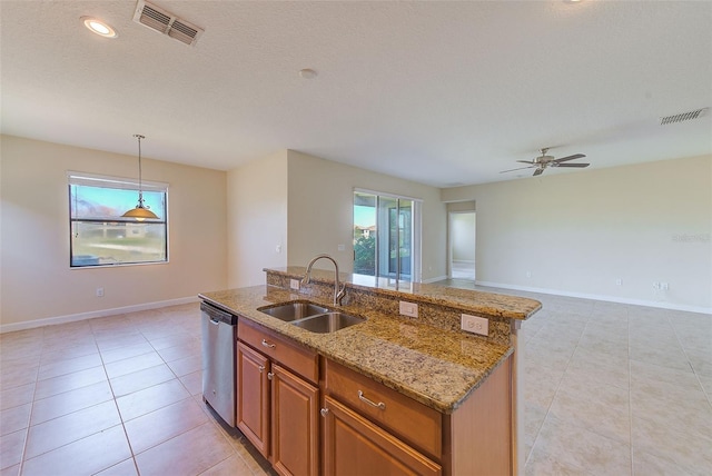 kitchen featuring a center island with sink, sink, hanging light fixtures, stainless steel dishwasher, and ceiling fan