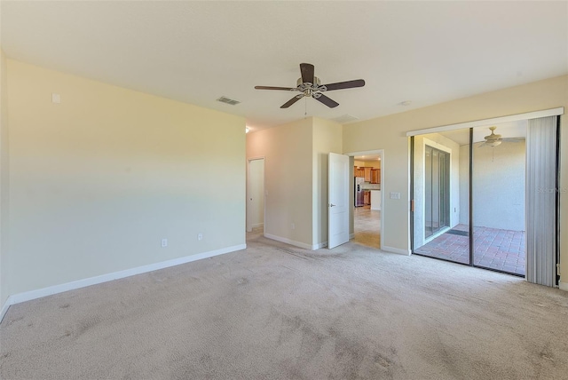 carpeted empty room with ceiling fan