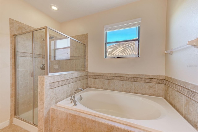 bathroom featuring separate shower and tub