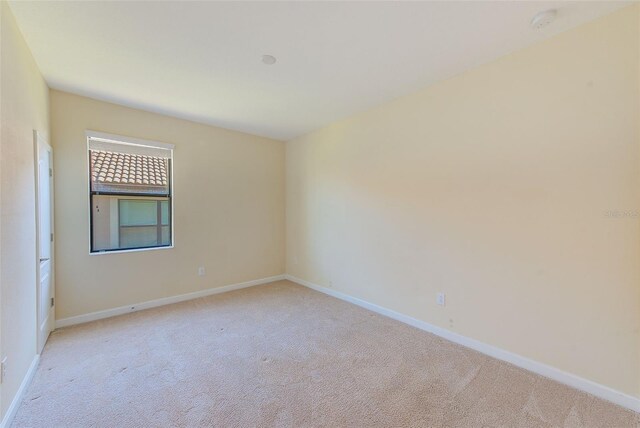 unfurnished room featuring light colored carpet