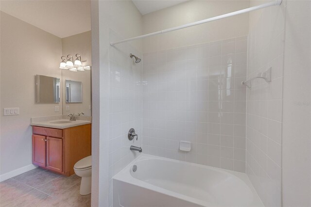 full bathroom featuring vanity, tiled shower / bath combo, toilet, and tile patterned flooring