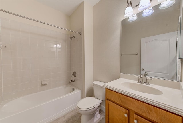 full bathroom featuring tile patterned flooring, tiled shower / bath combo, toilet, and vanity