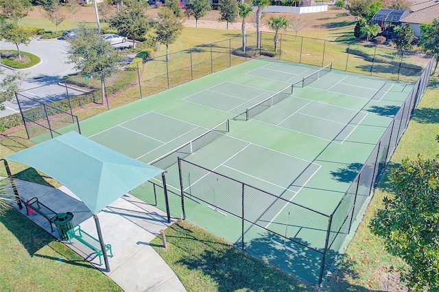 view of sport court with a yard