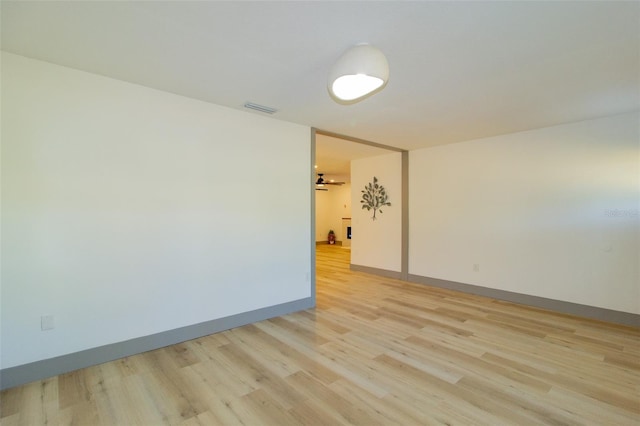 unfurnished room with ceiling fan and light wood-type flooring