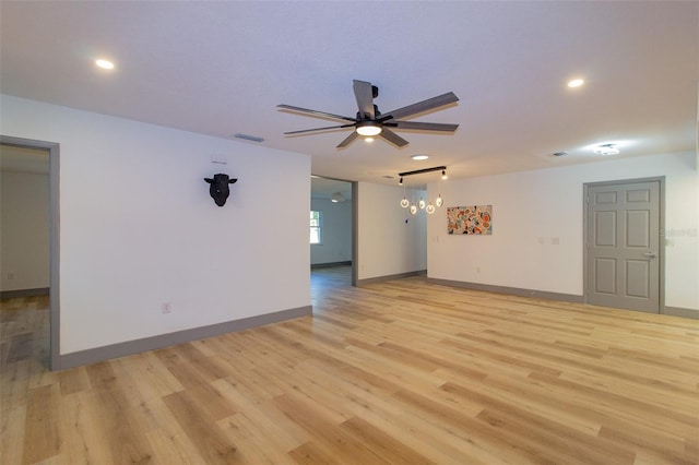 unfurnished room featuring ceiling fan and light wood-type flooring