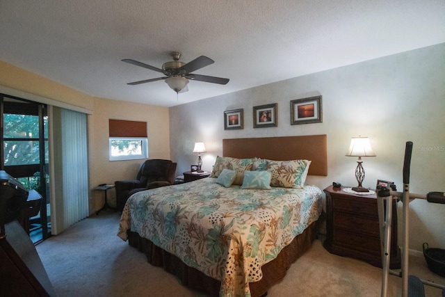 bedroom featuring carpet, a textured ceiling, and ceiling fan