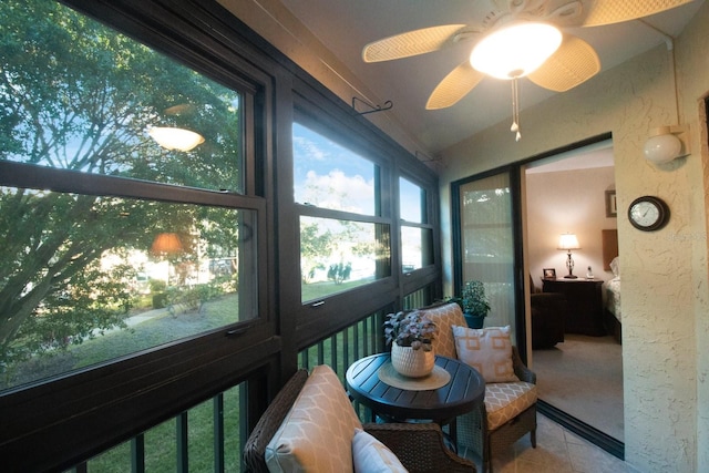 sunroom featuring ceiling fan and a wealth of natural light