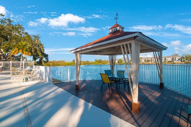 view of dock featuring a gazebo and a water view