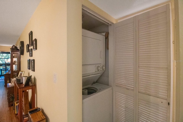 clothes washing area featuring stacked washer / drying machine