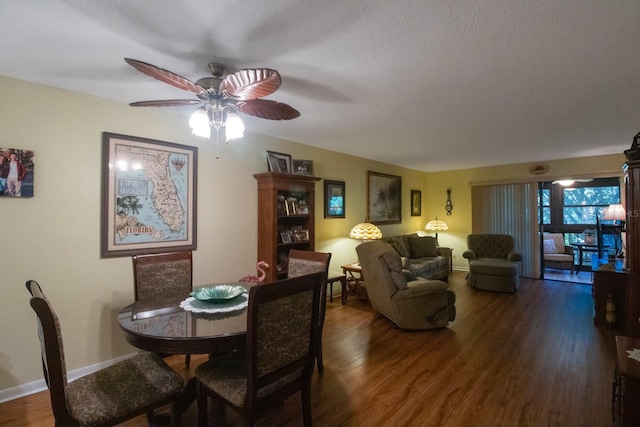 dining area featuring ceiling fan, dark hardwood / wood-style flooring, and a textured ceiling