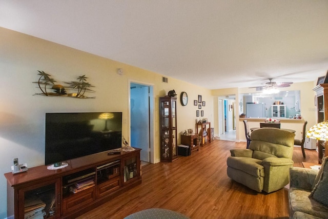 living room with hardwood / wood-style floors and ceiling fan