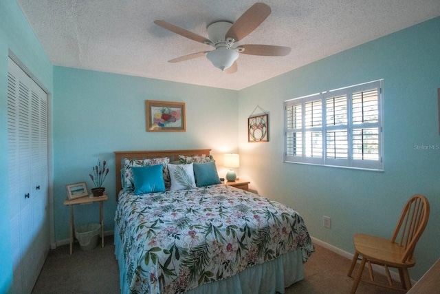 carpeted bedroom with ceiling fan, a closet, and a textured ceiling