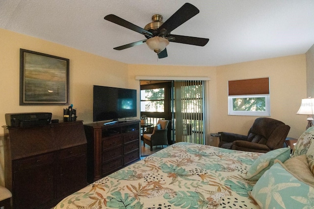 bedroom featuring multiple windows, access to outside, and ceiling fan