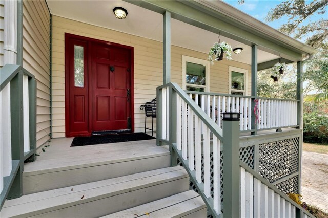 view of exterior entry with a porch