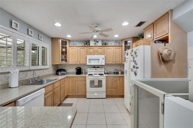 kitchen with ceiling fan, sink, light brown cabinets, backsplash, and white appliances