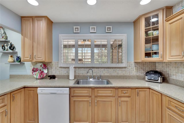 kitchen with decorative backsplash, sink, white dishwasher, and light brown cabinets