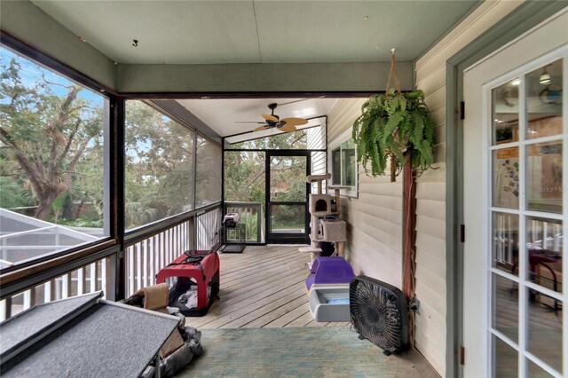 sunroom / solarium featuring ceiling fan and vaulted ceiling