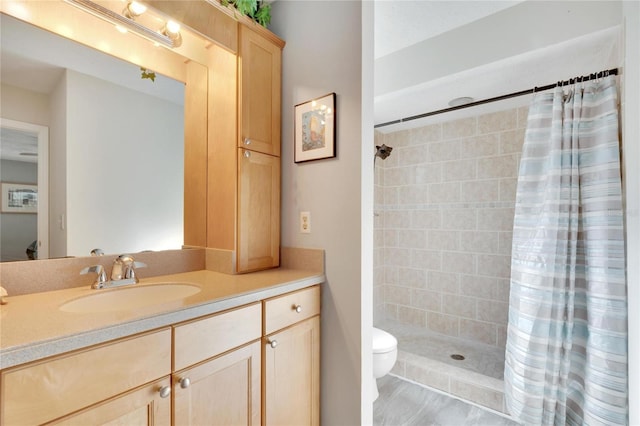 bathroom featuring vanity, curtained shower, and toilet