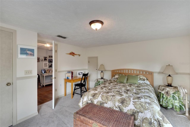 carpeted bedroom featuring a textured ceiling