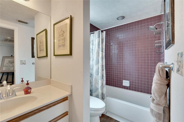 full bathroom featuring vanity, toilet, shower / bathtub combination with curtain, and a textured ceiling