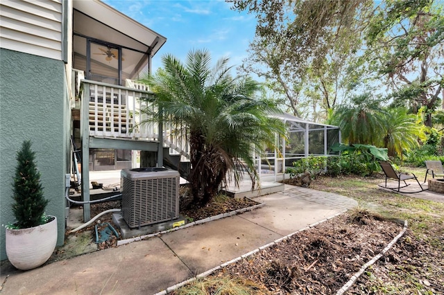 view of yard featuring a lanai, a patio, and central AC unit