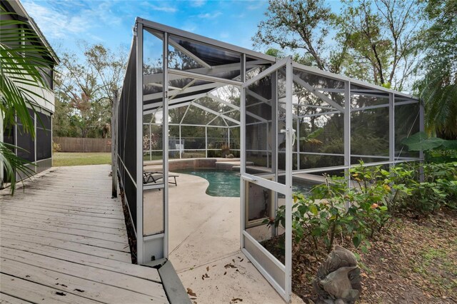 deck with a fenced in pool and a lanai