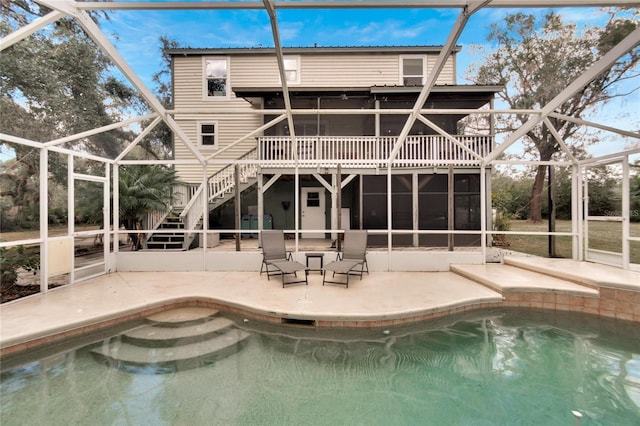 rear view of house with a lanai and a patio area