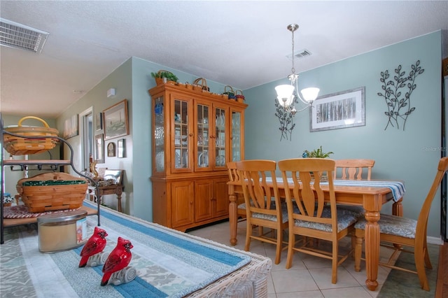 tiled dining space with a notable chandelier