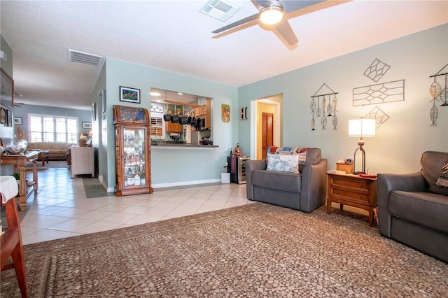 tiled living room with ceiling fan