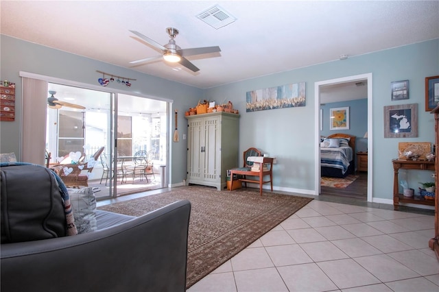 living room featuring ceiling fan and light tile patterned floors