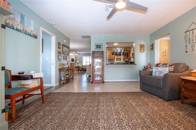 living room featuring tile patterned floors and ceiling fan