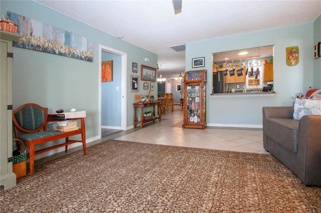 tiled living room featuring a chandelier