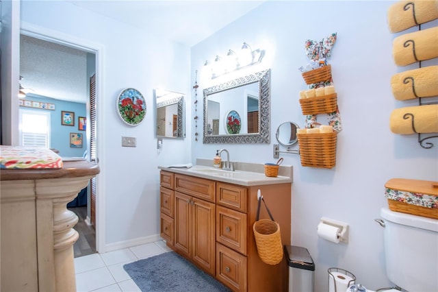 bathroom featuring tile patterned flooring, vanity, and toilet