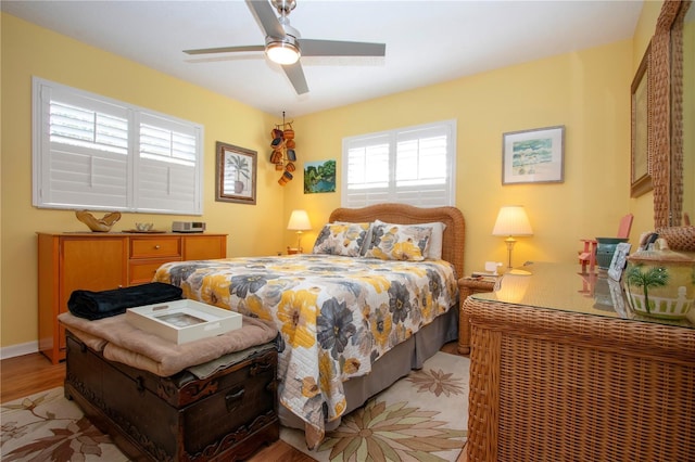 bedroom with ceiling fan and light wood-type flooring