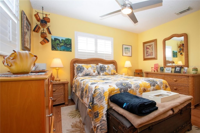 bedroom with ceiling fan and light hardwood / wood-style floors