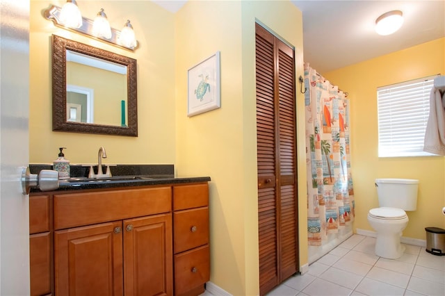 bathroom featuring tile patterned floors, vanity, and toilet