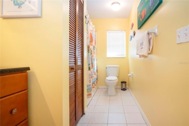 bathroom with tile patterned flooring, vanity, and toilet