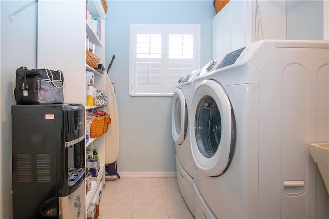 laundry room featuring light tile patterned floors and washing machine and clothes dryer